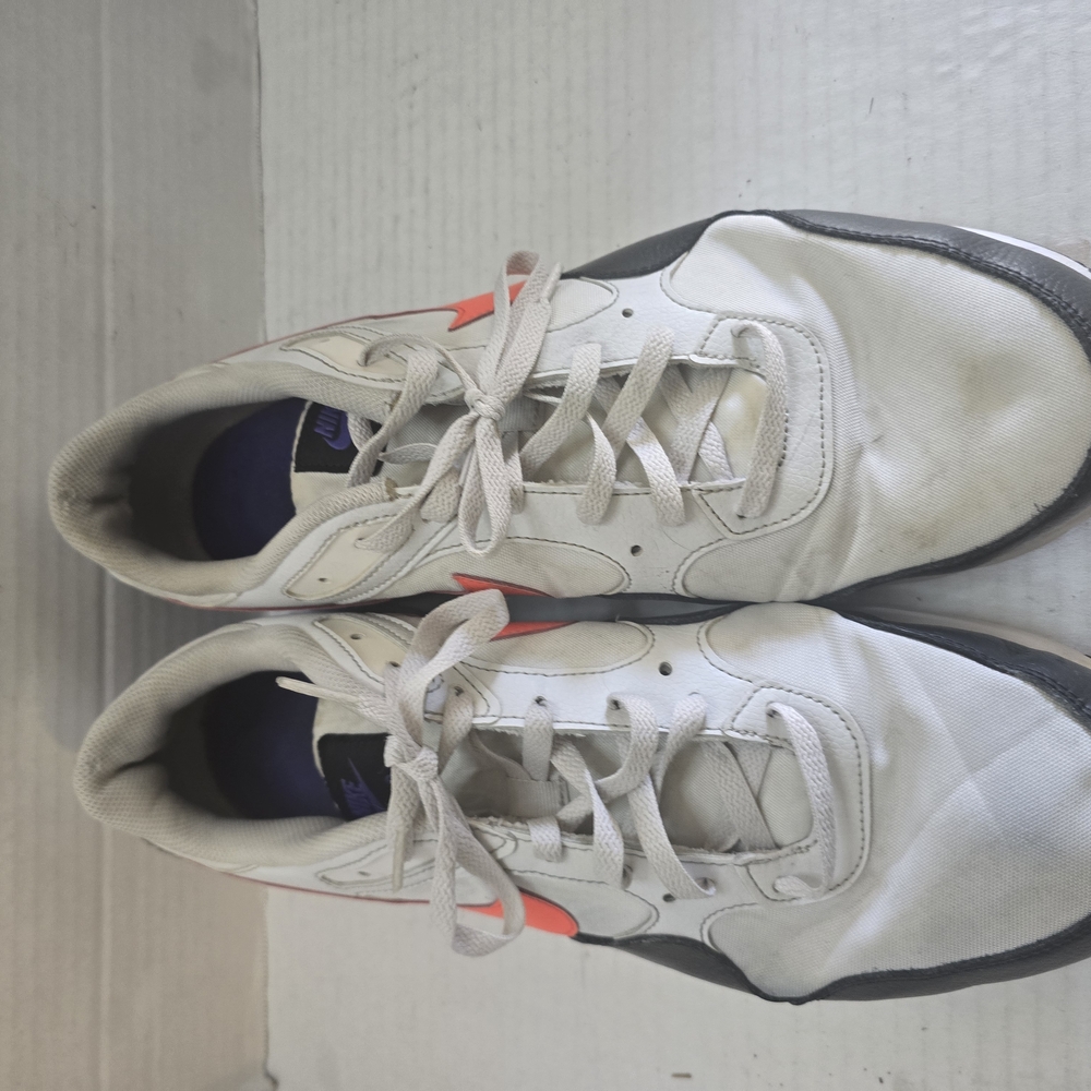 White and Black Athletic Shoes with Orange Highlights